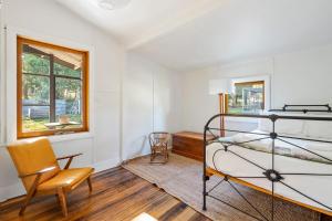 une chambre avec un lit superposé et une chaise dans l'établissement 'Questa' Heritage Cottage, à Barnes Bay