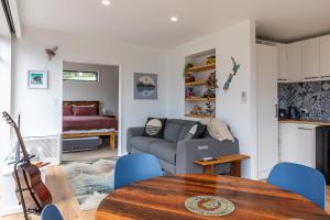 a living room with a couch and a table at Firkins Retreat, Picton in Picton