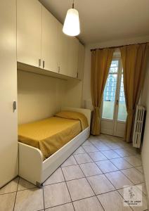 a small bedroom with a bed and a window at Made in Langhe Apartment in La Morra