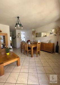 a living room with a dining room table and chairs at Made in Langhe Apartment in La Morra