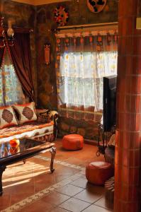 a living room with a couch and a tv at Villa Authentique avec Vue Panoramique à 3 km de Chefchaouen in Chefchaouene