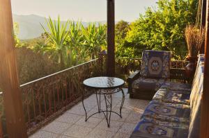 a patio with a table and a chair on a balcony at Villa Authentique avec Vue Panoramique à 3 km de Chefchaouen in Chefchaouen +75 photos