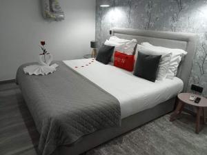 a bedroom with a large white bed with many pillows at O Salgueiro in Melo