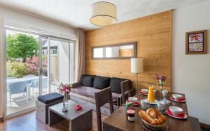 a living room with a table and a couch at Lagrange Vacances Le Clos Saint Hilaire in Saint-Lary-Soulan