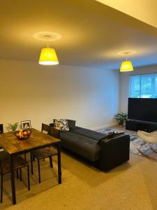 a living room with a couch and a table at The rest point in Bletchley