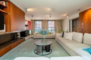 a living room with a couch and a table at The One Chelsea in London