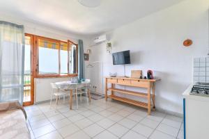 a kitchen with a table and a counter top at Le Lecce 34 in Capoliveri