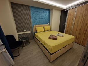 a bedroom with a bed with a purse on it at Square Vanilla Boutique Apart-Hotel in Skopje