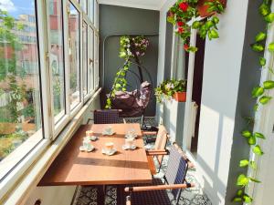 a small balcony with a table and chairs and windows at Alpacino Apart Hotel in Istanbul