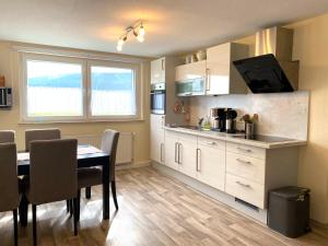 a kitchen with a table and a dining room at PferdeFairStand‘s Ferienwohnung in Haunetal