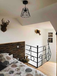 a bedroom with a bed andanimal heads on the wall at Gîte la Maison Rouge Béthune in Béthune