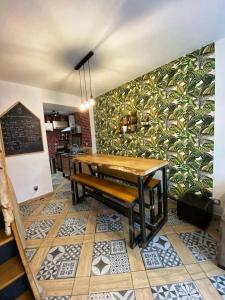 a dining room with a table and a mural at Gîte la Maison Rouge Béthune in Béthune