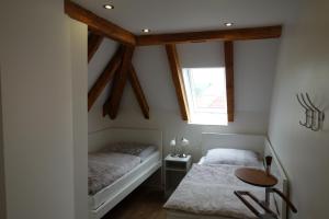 a bedroom with a bed and a table and a window at Ferienwohnung & Wellness in Bad Kissingen