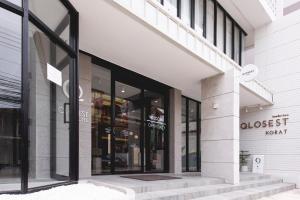 a close up of a store front with glass windows at Qlosest Hotel in Nakhon Ratchasima