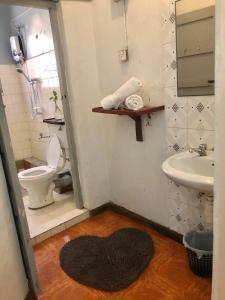 a bathroom with a toilet and a sink at the APARTMENT house in Mbale