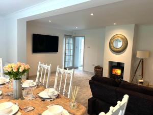 a dining room with a table and a fireplace at Number 8 in Midhurst