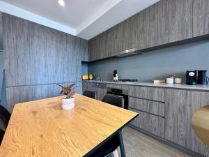 a kitchen with a wooden table with a plant on it at Luxury Top Level 1 Bedroom Apartment with Stunning View in Adelaide CBD - 1 minute walk to Rundle mall - Free Wifi & Netflix in Adelaide