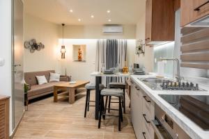 a kitchen and living room with a couch at Guest house (Gastouri) in Gastouri +13 photos