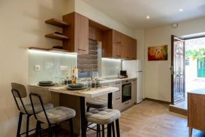 a kitchen with a counter and chairs in a room at Guest house (Gastouri) in Gastouri