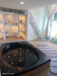 a bath tub in a room with a staircase at Departamento en playa caleta in Acapulco