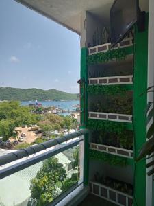 a room with a view of the ocean from a balcony at Departamento en playa caleta in Acapulco