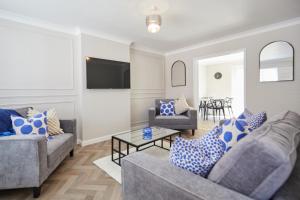 a living room with two couches and a tv at Freshly Refurbished Open-plan Dining & Kitchen in Norwich