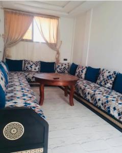 a living room with a couch and a table at Imsouane in Imsouane