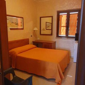 Postel nebo postele na pokoji v ubytování Hotel Ristorante Rinelli