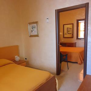 Postel nebo postele na pokoji v ubytování Hotel Ristorante Rinelli