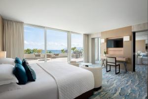 a bedroom with a large bed and a living room at JW Marriott Cannes in Cannes +93 photos