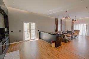 a large living room with a couch and a table at Vila Osmani in Ksamil