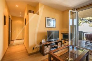 A television and/or entertainment centre at Xaloc by SeaMount Rentals