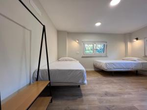 a bedroom with two beds and a window at Hostal Mindanao in Salamanca