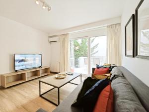 a living room with a couch and a tv at Kalipsous Apartments by Verde Apartments in Athens
