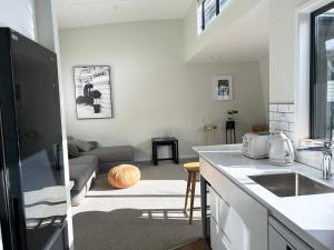 a kitchen and living room with a couch at Ultimate Location Luxury Retreat - 2 bedrooms 2 bathrooms in Mount Maunganui