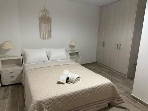 a bedroom with a bed with two towels on it at Piraiki Coastal Accommodation in Piraeus