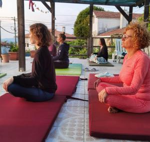 a group of people sitting on yoga mats at Pilgrims Rest - Vila Nova de Cerveira - Hostel - Albergue - AL in Vila Nova de Cerveira