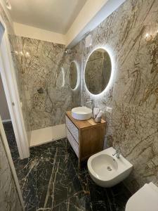 a bathroom with a sink and a toilet at Prestige Suite Via Romagnoli in Sirmione