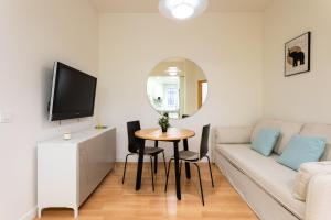 a living room with a couch and a table at Holidays2Malaga Victoria 40 Quiet & Central in Málaga