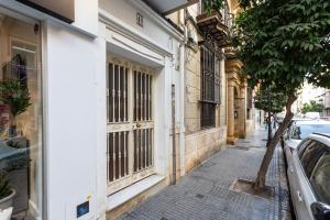 a street in the city with a car parked on the sidewalk at Holidays2Malaga Victoria 40 Quiet & Central in Málaga