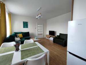 a living room with a couch and a table at ApartHome K8 Centrum Sulęcin in Sulęcin