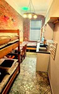 a room with two bunk beds and a kitchen at Studio Centrum Wejście na kod Code entry in Szczecin
