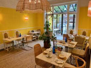 a restaurant with tables and chairs in a room at 15 Grosvenor in Hastings