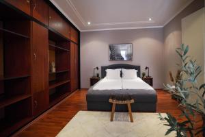 a bedroom with a bed and a table in it at Hygge Home Apartman in Eger