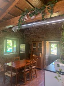 a dining room with a wooden table and chairs at Casa do Castiro in Palas de Rei