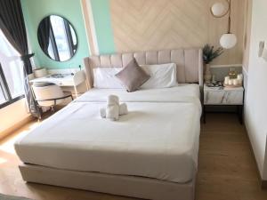 a bedroom with a white teddy bear sitting on a bed at BBCC APARTMENT AT LUCENTIA 2 in Kuala Lumpur