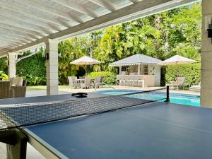 a ping pong court in a house with a pool at Royal Palms, St James in Saint James