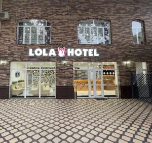 a store front of a louva hotel on a brick building at Lola Kokand Hotel in Kokand