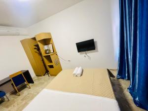 a room with a bed and a flat screen tv at Dream Apartment in Mestre