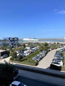 a parking lot with a bunch of parked cars at Studio Horizon Bleu, vue mer in Calais